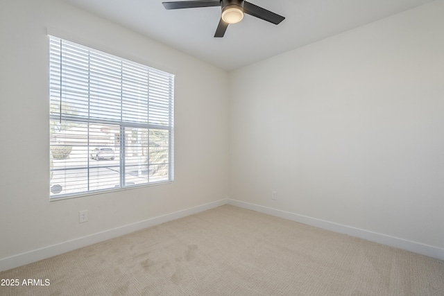 unfurnished room featuring light colored carpet and ceiling fan