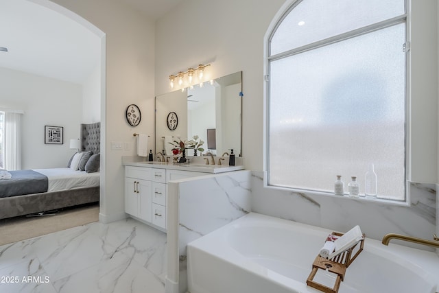 bathroom with vanity and a washtub