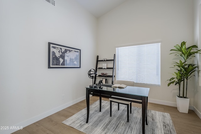 office area featuring lofted ceiling and light hardwood / wood-style flooring