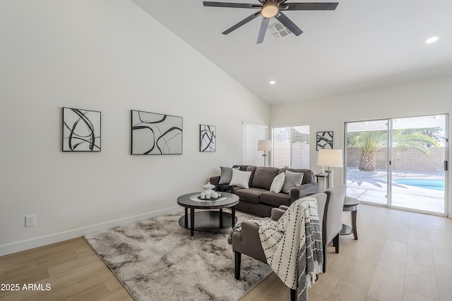 living room with high vaulted ceiling, light hardwood / wood-style floors, and ceiling fan