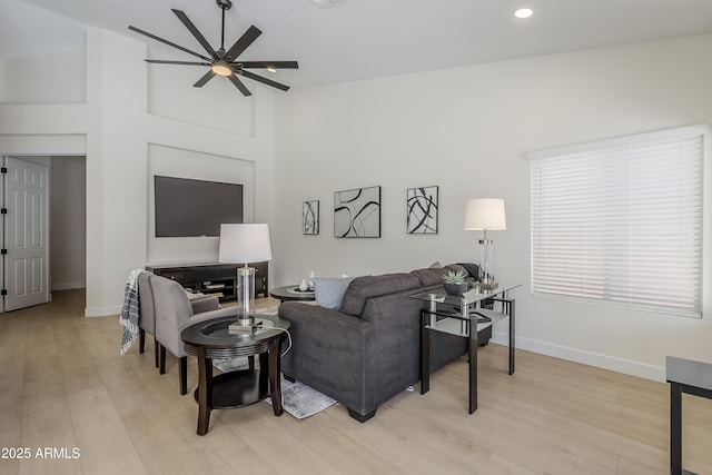 living room with ceiling fan and light hardwood / wood-style floors