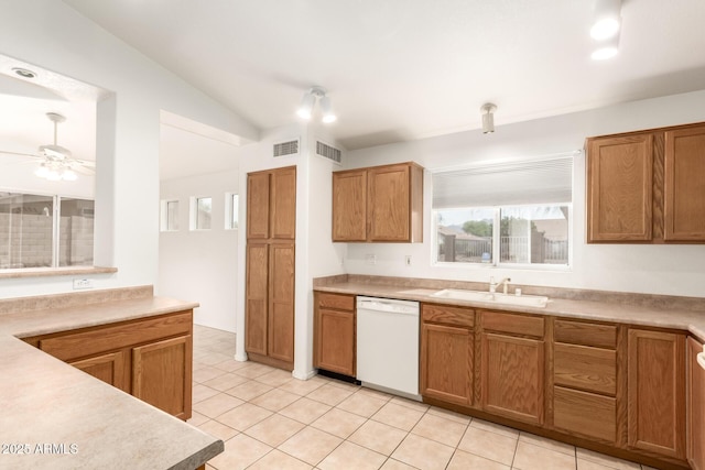 kitchen with visible vents, a sink, dishwasher, and vaulted ceiling