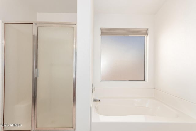 full bathroom featuring a garden tub and a stall shower