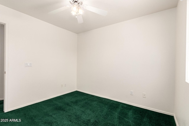 spare room with baseboards, ceiling fan, and dark carpet