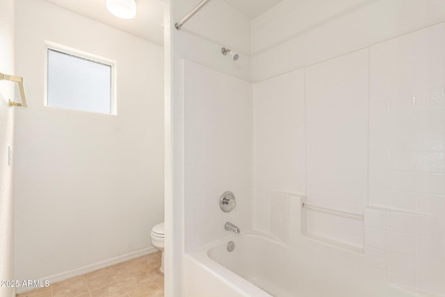 bathroom with toilet,  shower combination, baseboards, and tile patterned flooring