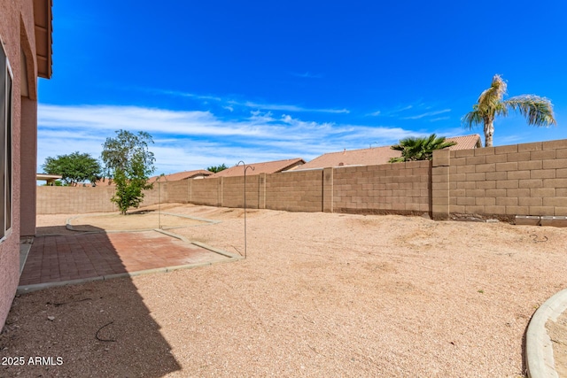 view of yard with a fenced backyard and a patio