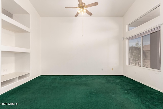 carpeted spare room with baseboards and a ceiling fan