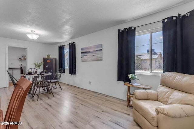 sitting room with a textured ceiling and light hardwood / wood-style flooring