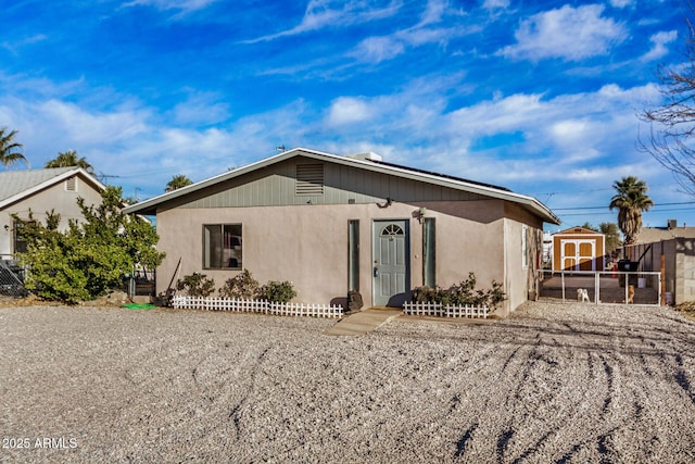 view of front of house featuring a storage shed