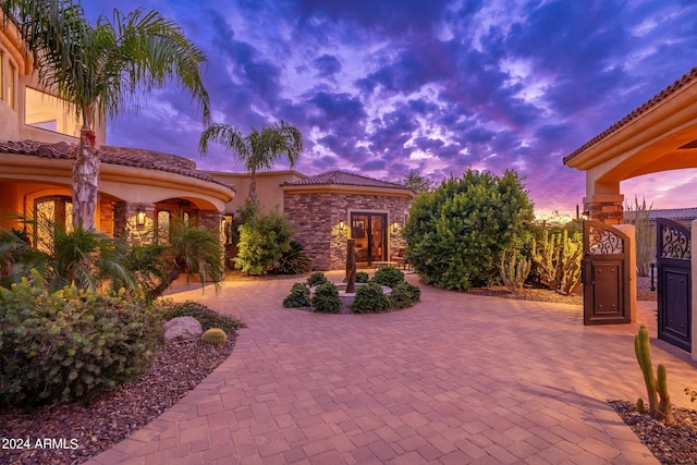 view of patio terrace at dusk