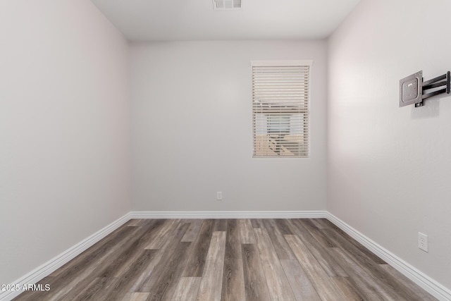 empty room featuring dark wood-type flooring