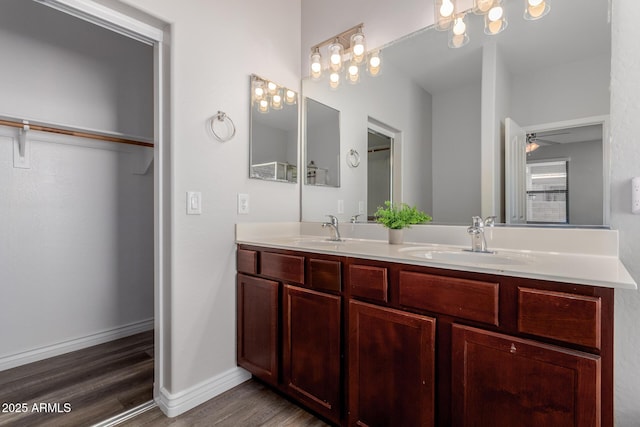 bathroom with vanity, hardwood / wood-style floors, and ceiling fan