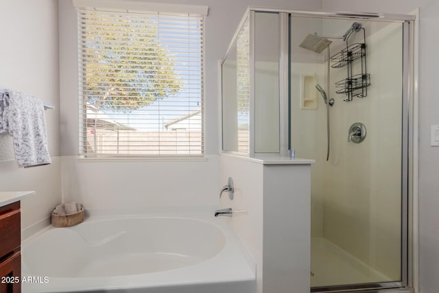 bathroom featuring vanity and plus walk in shower