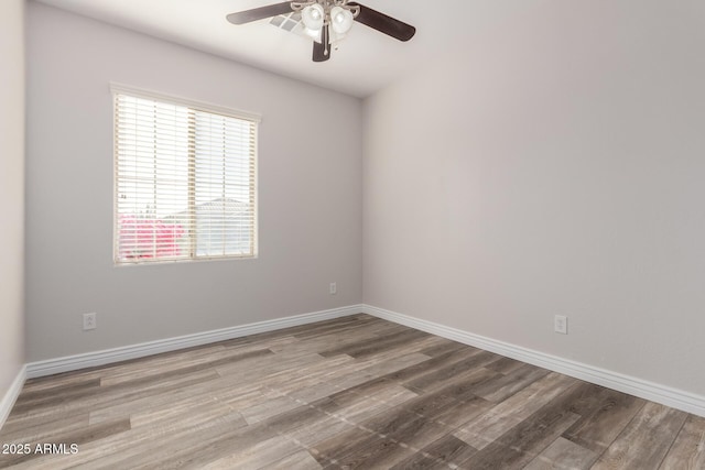 unfurnished room with hardwood / wood-style floors and ceiling fan