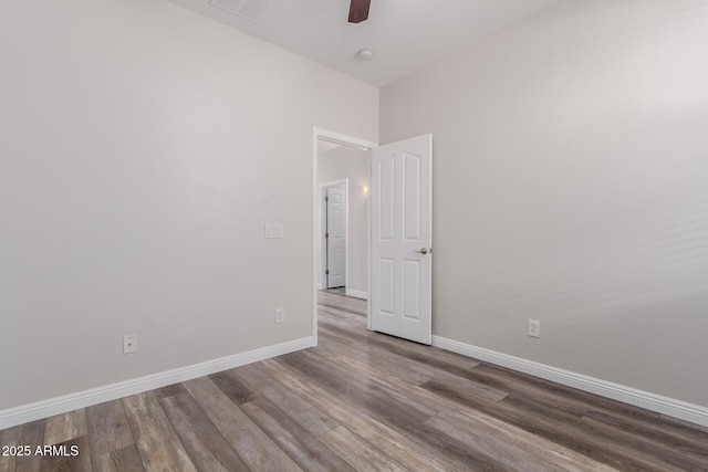 empty room with hardwood / wood-style floors and ceiling fan