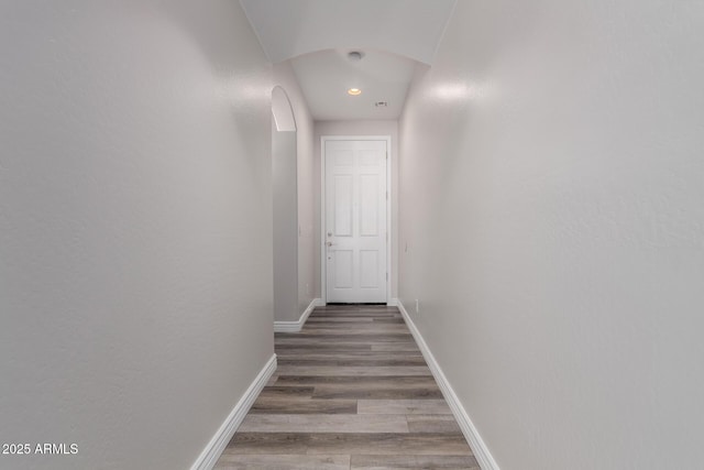 hallway with hardwood / wood-style flooring