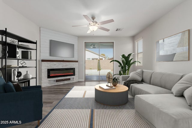 living room featuring dark hardwood / wood-style floors and ceiling fan