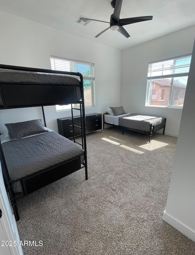 bedroom with visible vents, carpet flooring, a ceiling fan, and baseboards