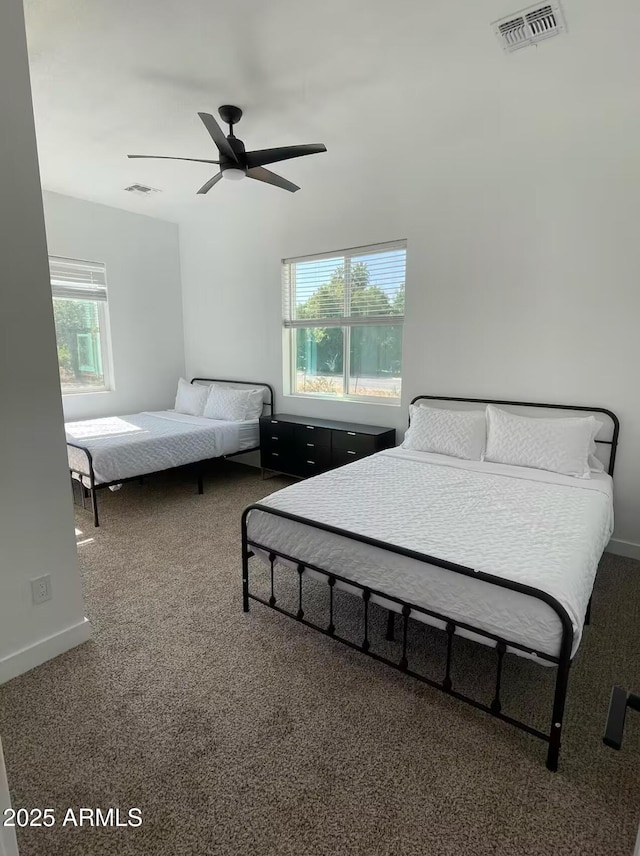 bedroom featuring a ceiling fan, carpet flooring, visible vents, and baseboards