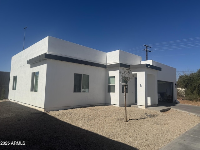 view of front of home with an attached garage and stucco siding