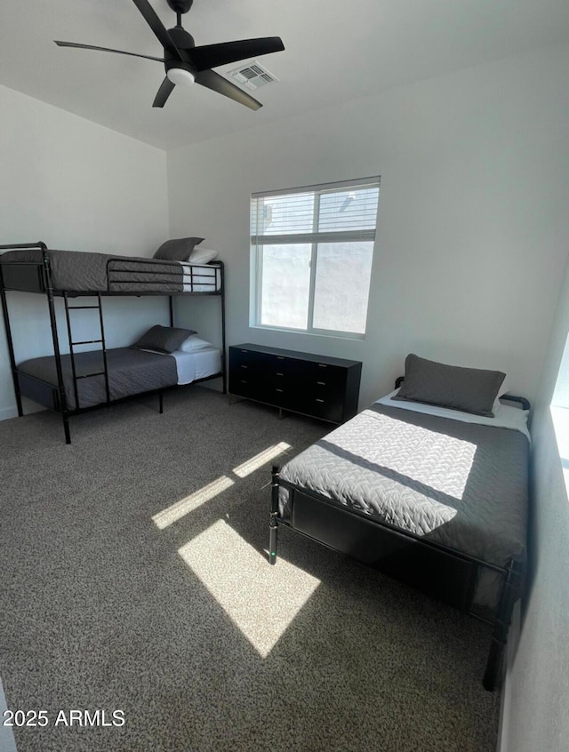 bedroom featuring a ceiling fan, visible vents, and carpet flooring