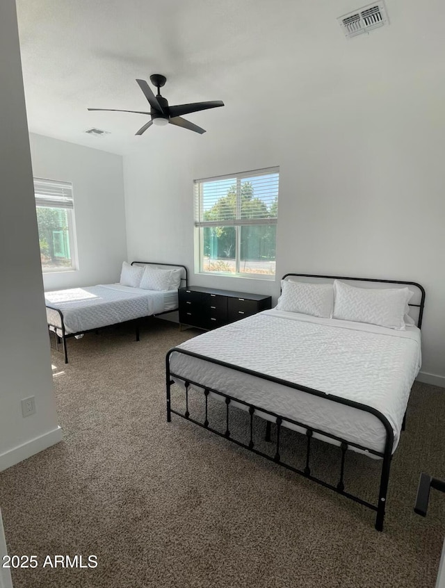 bedroom featuring a ceiling fan, carpet, visible vents, and baseboards