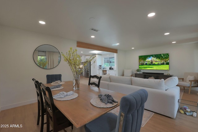 dining space with recessed lighting, visible vents, baseboards, stairs, and light wood-style floors