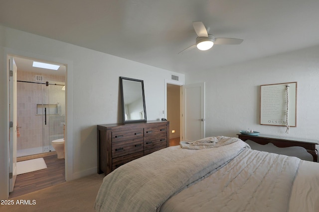 carpeted bedroom featuring ensuite bathroom, ceiling fan, visible vents, and baseboards