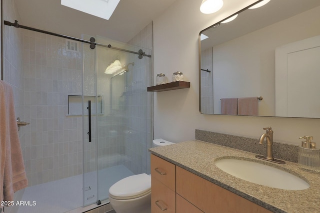 full bath with a skylight, visible vents, toilet, a shower stall, and vanity