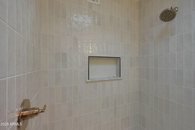 bathroom with tiled shower