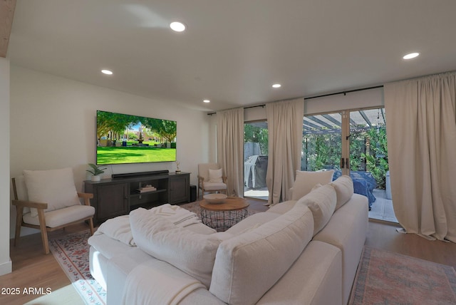 living room featuring light wood-type flooring and recessed lighting