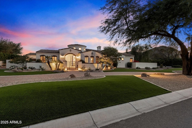 mediterranean / spanish-style house featuring a lawn