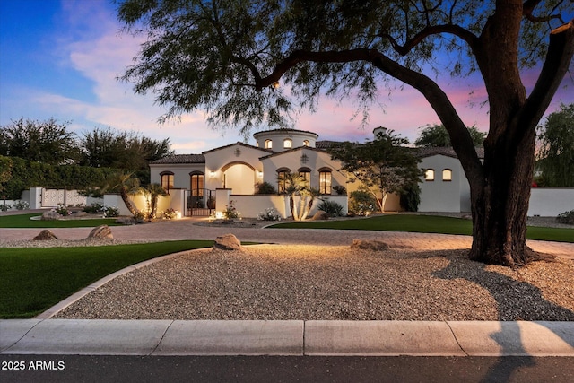 mediterranean / spanish house with a lawn