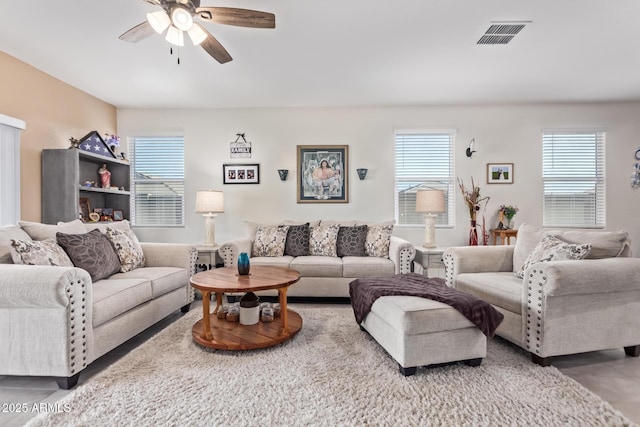 living room with tile patterned flooring, a wealth of natural light, and ceiling fan