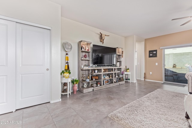 tiled living room with ceiling fan