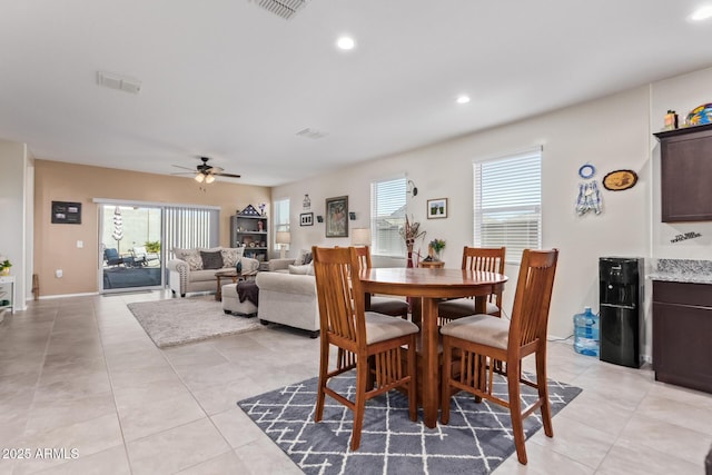 tiled dining area with ceiling fan