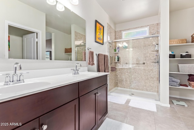 bathroom featuring tile patterned floors, vanity, and a shower with shower door