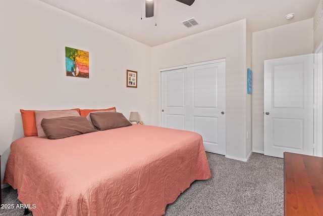 carpeted bedroom with ceiling fan and a closet