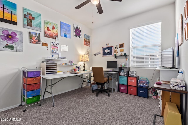 carpeted office space featuring ceiling fan