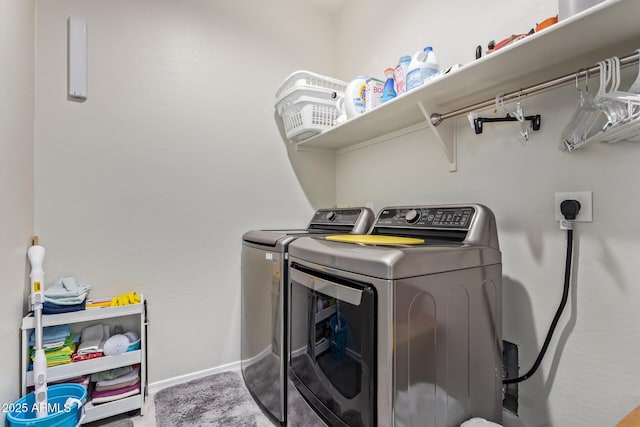 clothes washing area with washing machine and dryer and carpet