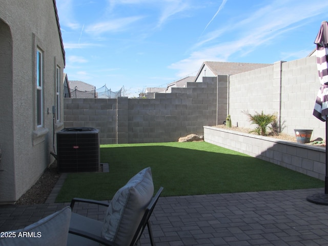 view of yard with a patio area and central air condition unit