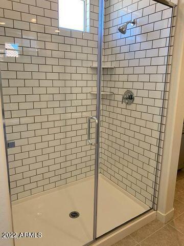 bathroom featuring tile patterned floors and an enclosed shower