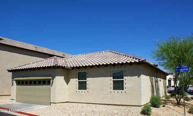 view of side of property with a garage