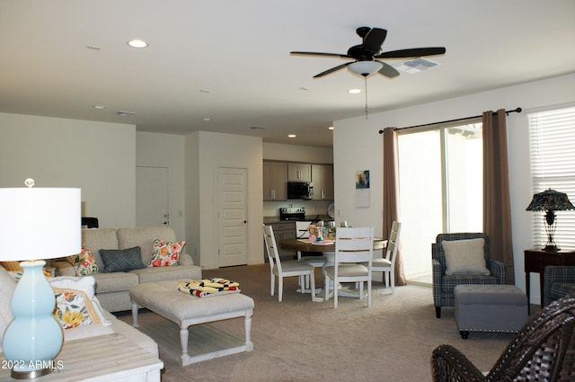 carpeted living room with ceiling fan