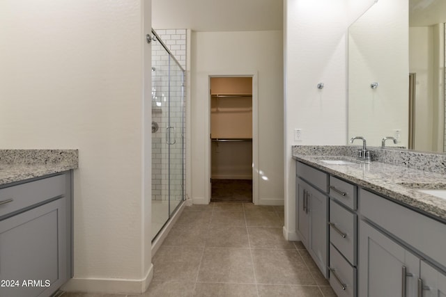 bathroom with tile patterned flooring, vanity, and an enclosed shower