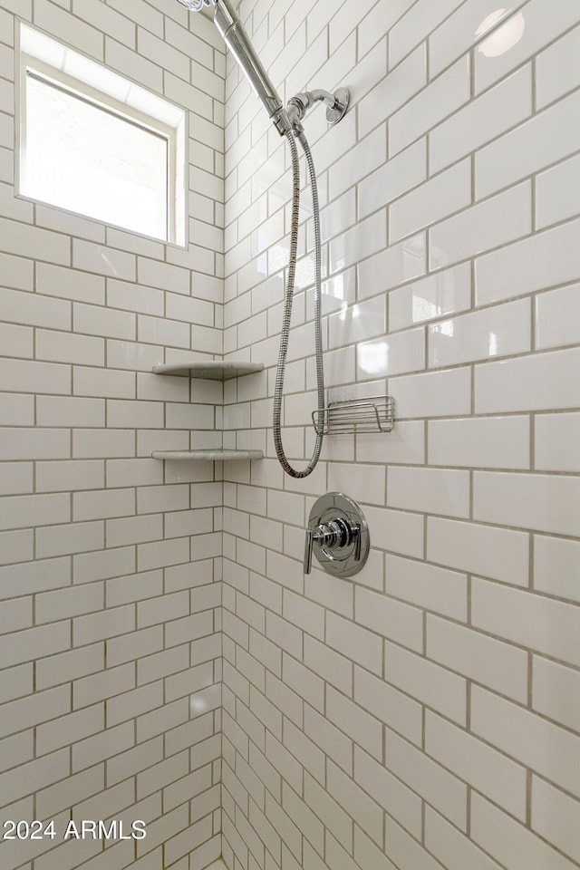 bathroom with a tile shower