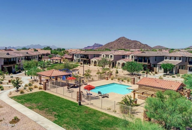 view of pool featuring a lawn, a mountain view, and a patio