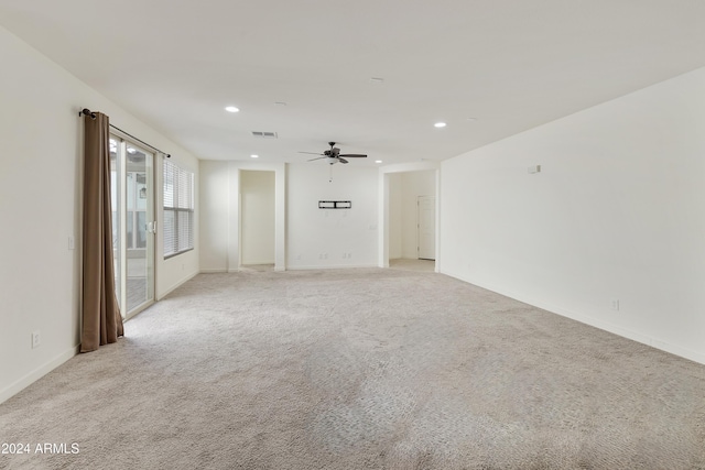 unfurnished room with ceiling fan and light colored carpet