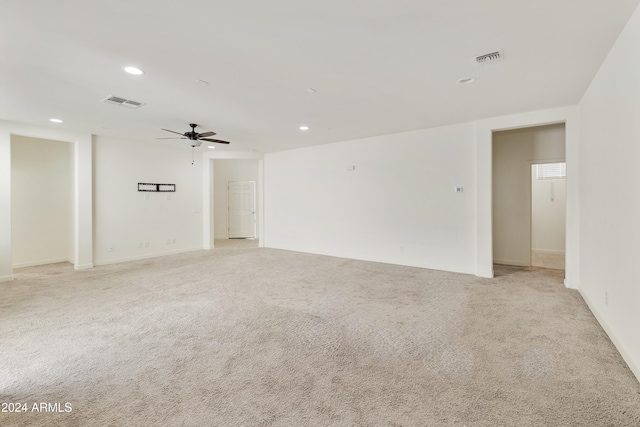 unfurnished room with light colored carpet and ceiling fan