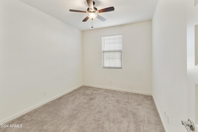 spare room with light carpet and ceiling fan